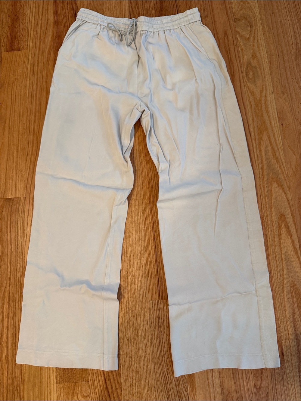 Cream Drawstring pants with slit side pockets and ribbon detailing on sides